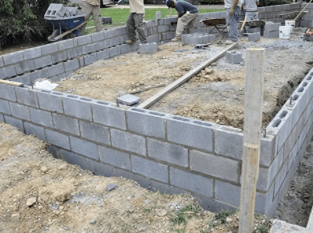 Professionals building a foundation with blocks in Overland Park, KS